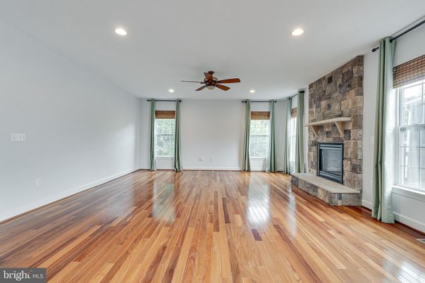Empty room, Fireplace, Interior, Recessed Lighting, Stone Walls, Wood Texture Flooring