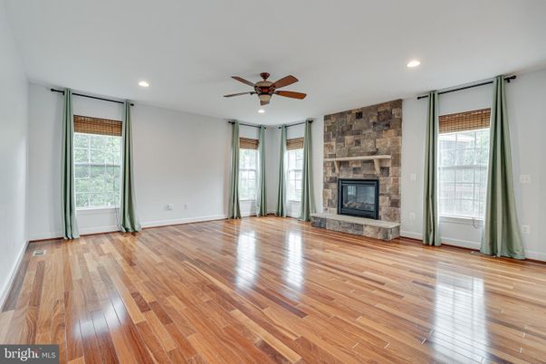 Empty room, Fireplace, Interior, Recessed Lighting, Stone Walls, Wood Texture Flooring