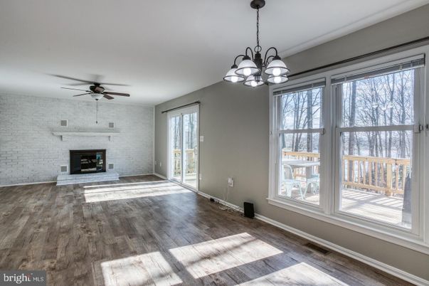 Chandelier, Empty room, Fireplace, Interior, Stone Walls, Wood Texture Flooring