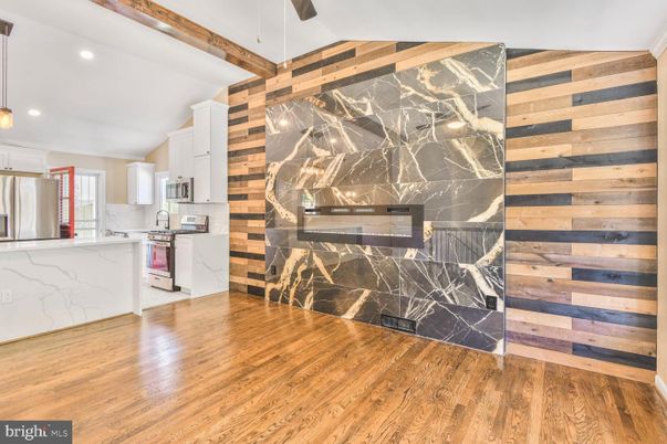 Interior, Kitchen, Marble Walls, Recessed Lighting, Stainless Steel Appliances, Wood Texture Flooring