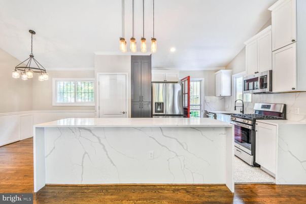 Interior, Kitchen, Marble Walls, Pendant Lights, Recessed Lighting, Stainless Steel Appliances, Wood Texture Flooring