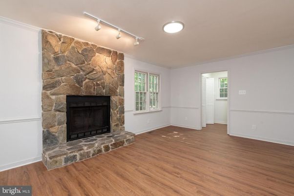 Empty room, Fireplace, Interior, Recessed Lighting, Stone Walls, Wood Texture Flooring