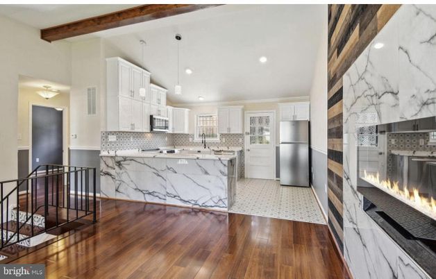 Fireplace, Interior, Kitchen, Marble Walls, Pendant Lights, Recessed Lighting, Stainless Steel Appliances, Wooden Beams, Wood Texture Flooring