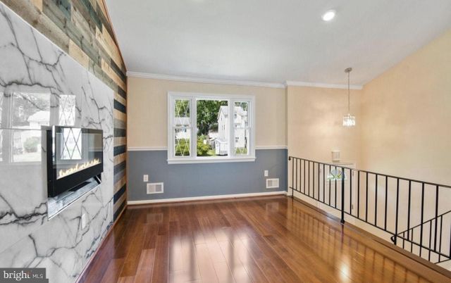 Fireplace, Interior, Marble Walls, Pendant Lights, Recessed Lighting, Wood Texture Flooring