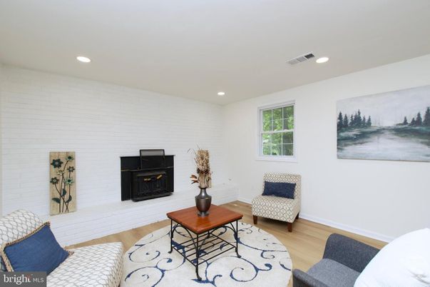 Fireplace, Interior, Living room, Recessed Lighting, Stone Walls, Wood Texture Flooring