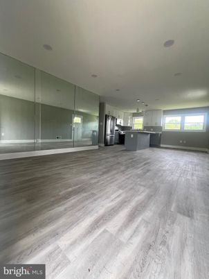 Empty room, Interior, Kitchen, Pendant Lights, Recessed Lighting, Stainless Steel Appliances, Wood Texture Flooring