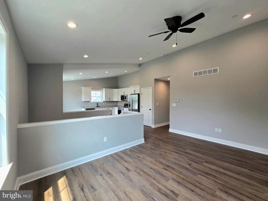Empty room, Interior, Kitchen, Recessed Lighting, Stainless Steel Appliances, Wood Texture Flooring