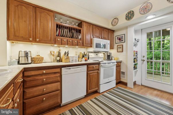 Interior, Kitchen, Recessed Lighting, Tile Countertops, Wood Texture Flooring