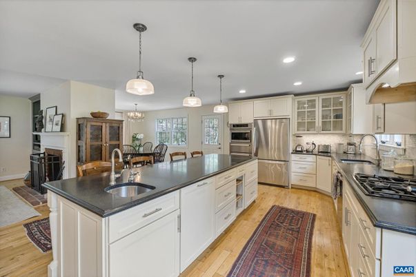 Chandelier, Dining room, Fireplace, Interior, Kitchen, Pendant Lights, Recessed Lighting, Stainless Steel Appliances, Wood Texture Flooring