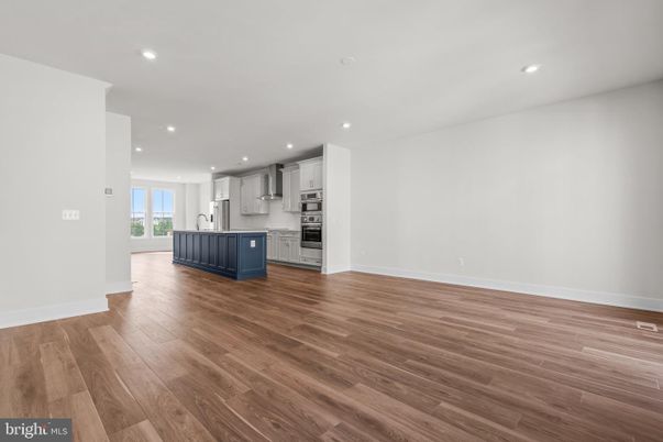 Empty room, Interior, Kitchen, Recessed Lighting, Stainless Steel Appliances, Wood Texture Flooring