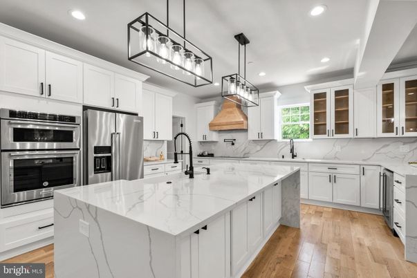 Interior, Kitchen, Marble Walls, Pendant Lights, Recessed Lighting, Stainless Steel Appliances, Wood Texture Flooring