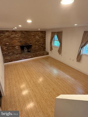 Empty room, Fireplace, Interior, Recessed Lighting, Stone Walls, Wood Texture Flooring