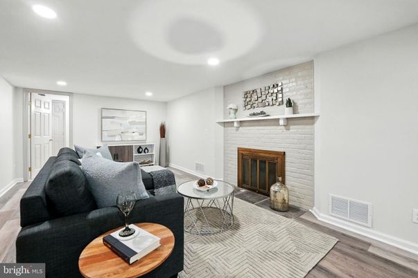 Fireplace, Interior, Living room, Recessed Lighting, Stone Walls, Wood Texture Flooring