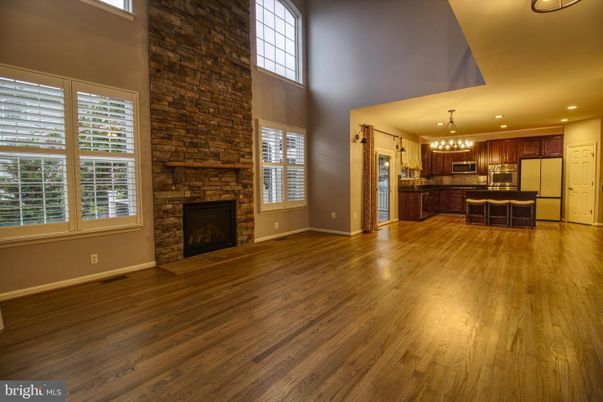 Chandelier, Empty room, Fireplace, Interior, Kitchen, Pendant Lights, Recessed Lighting, Stone Walls, Wood Texture Flooring