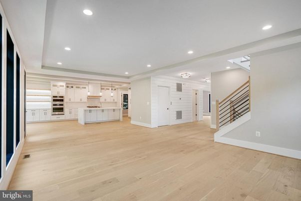Empty room, Interior, Kitchen, Recessed Lighting, Stainless Steel Appliances, Wood Texture Flooring