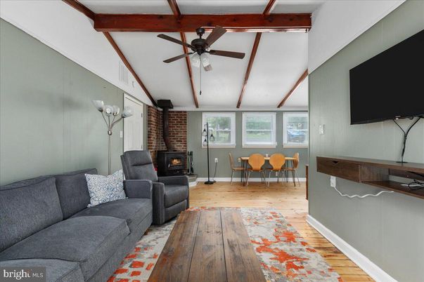 Dining room, Fireplace, Interior, Living room, Stone Walls, Wooden Beams, Wood Texture Flooring