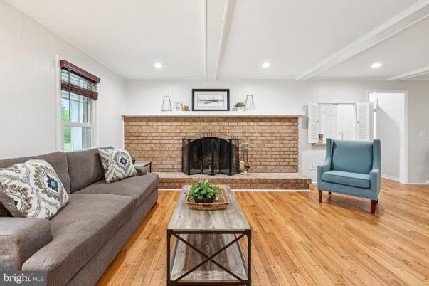 Fireplace, Interior, Living room, Recessed Lighting, Stone Walls, Wood Texture Flooring