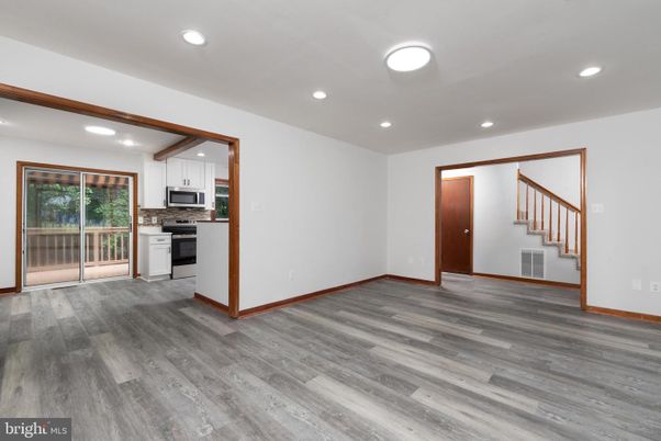 Empty room, Interior, Kitchen, Recessed Lighting, Stainless Steel Appliances, Wood Texture Flooring