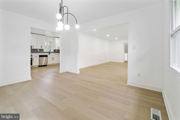 Empty room, Interior, Kitchen, Pendant Lights, Recessed Lighting, Stainless Steel Appliances, Wood Texture Flooring