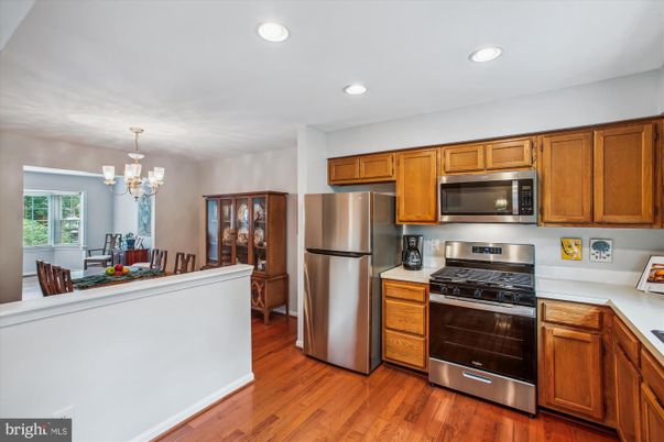 Chandelier, Dining room, Interior, Kitchen, Recessed Lighting, Stainless Steel Appliances, Wood Texture Flooring