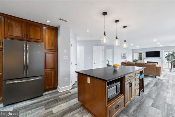 Fireplace, Interior, Kitchen, Living room, Pendant Lights, Recessed Lighting, Stainless Steel Appliances, Wood Texture Flooring