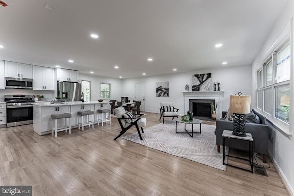 Dining room, Fireplace, Interior, Kitchen, Living room, Recessed Lighting, Stainless Steel Appliances, Wood Texture Flooring