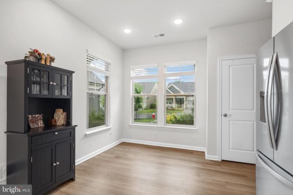 Empty room, Interior, Kitchen, Recessed Lighting, Stainless Steel Appliances, Wood Texture Flooring