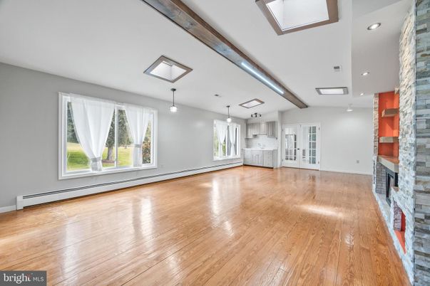 Empty room, Fireplace, Interior, Pendant Lights, Recessed Lighting, Stone Walls, Wooden Beams, Wood Texture Flooring