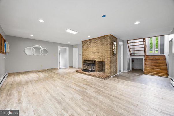 Empty room, Fireplace, Interior, Recessed Lighting, Stone Walls, Wood Texture Flooring