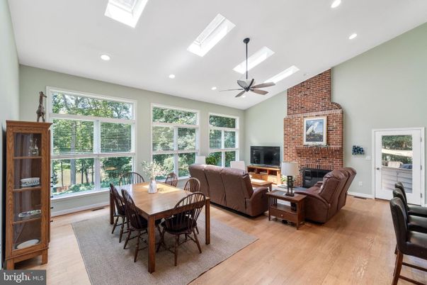 Dining room, Fireplace, Interior, Living room, Recessed Lighting, Stone Walls, Wood Texture Flooring