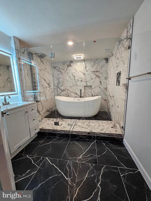 Bathroom, Dual Sink Vanities, Free Standing Baths, Interior, Marble, Marble Walls, Recessed Lighting