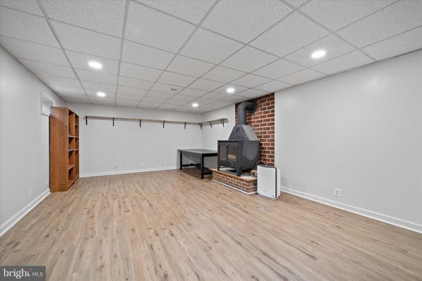 Empty room, Fireplace, Interior, Recessed Lighting, Stone Walls, Wood Texture Flooring