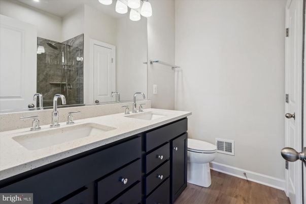 Bathroom, Dual Sink Vanities, Glass Shower, Interior, Recessed Lighting, Wood Texture Flooring
