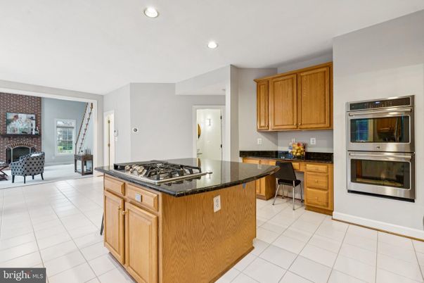 Fireplace, Interior, Kitchen, Recessed Lighting, Stainless Steel Appliances, Stone Walls