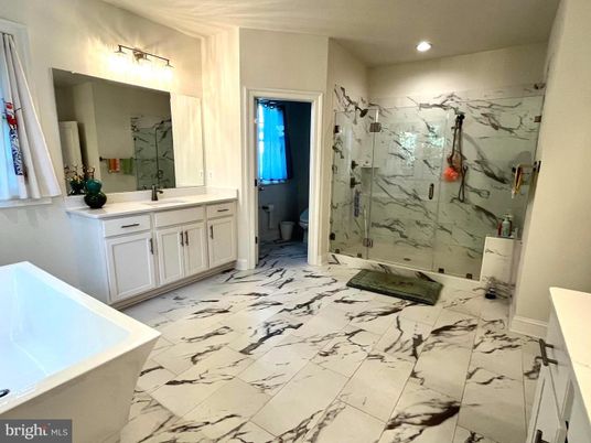 Bathroom, Dual Sink Vanities, Glass Shower, Interior, Marble, Marble Walls, Recessed Lighting