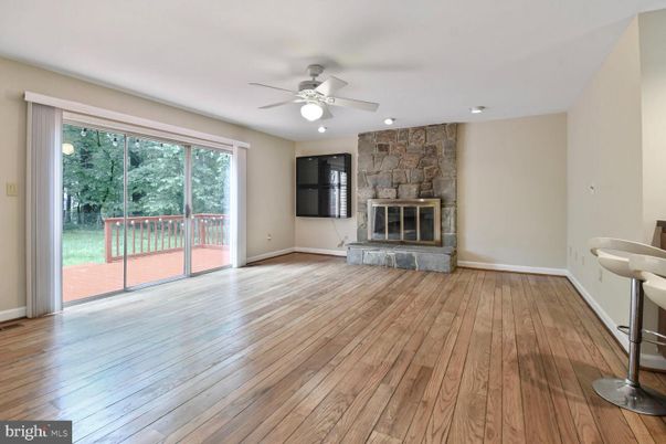 Empty room, Fireplace, Interior, Recessed Lighting, Stone Walls, Wood Texture Flooring