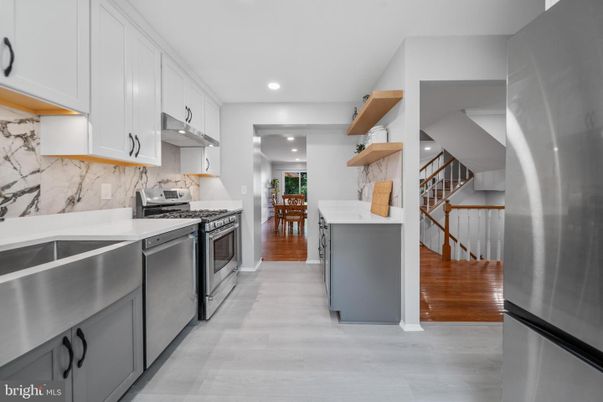 Interior, Kitchen, Marble Walls, Recessed Lighting, Stainless Steel Appliances, Wood Texture Flooring