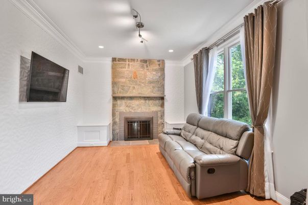 Fireplace, Interior, Living room, Recessed Lighting, Stone Walls, Wood Texture Flooring