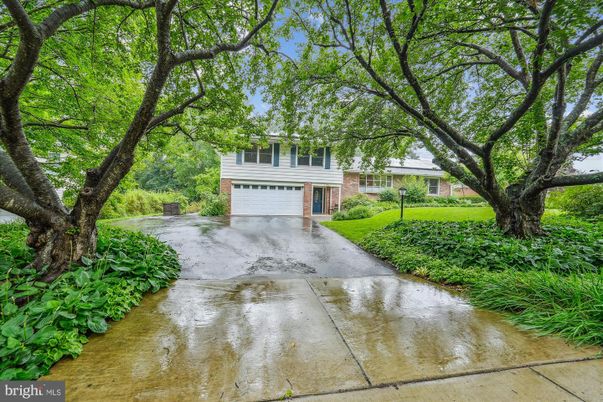 Attached, Backyard, Exterior, Facade, Brick Facade, Raised Ranch
