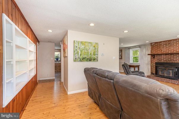 Fireplace, Interior, Living room, Recessed Lighting, Stone Walls, Wood Texture Flooring