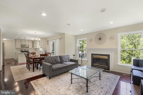 Chandelier, Dining room, Fireplace, Interior, Kitchen, Living room, Pendant Lights, Recessed Lighting, Stainless Steel Appliances, Wood Texture Flooring