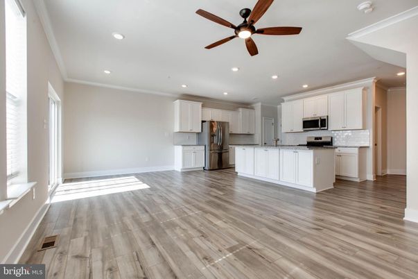 Empty room, Interior, Kitchen, Recessed Lighting, Stainless Steel Appliances, Wood Texture Flooring