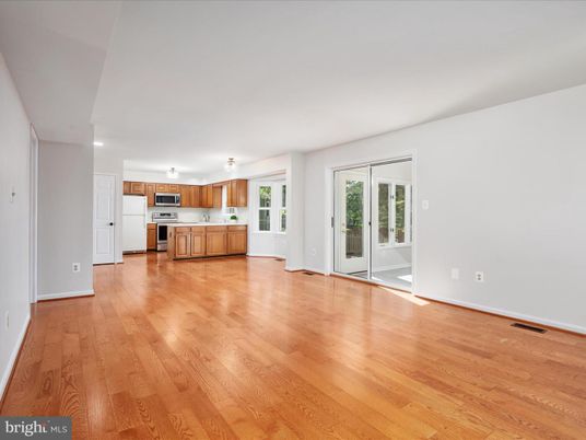 Empty room, Interior, Kitchen, Recessed Lighting, Stainless Steel Appliances, Wood Texture Flooring