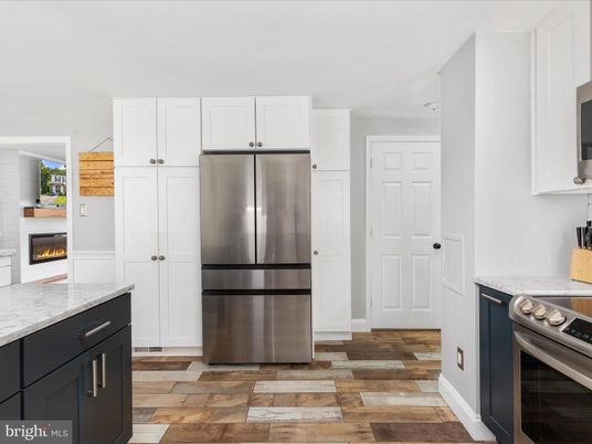 Fireplace, Interior, Kitchen, Stainless Steel Appliances, Wood Texture Flooring
