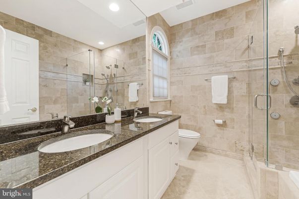 Bathroom, Dual Sink Vanities, Glass Shower, Interior, Recessed Lighting, Stone Walls