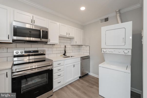 Interior, Kitchen, Recessed Lighting, Stainless Steel Appliances, Washer, Wood Texture Flooring