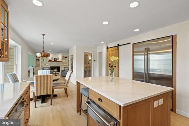 Dining room, Fireplace, Interior, Kitchen, Pendant Lights, Recessed Lighting, Stainless Steel Appliances, Wood Texture Flooring