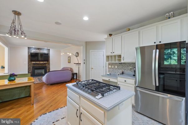 Fireplace, Interior, Kitchen, Living room, Pendant Lights, Recessed Lighting, Stainless Steel Appliances, Wood Texture Flooring