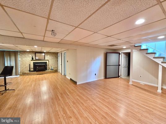 Empty room, Fireplace, Interior, Recessed Lighting, Stone Walls, Wood Texture Flooring