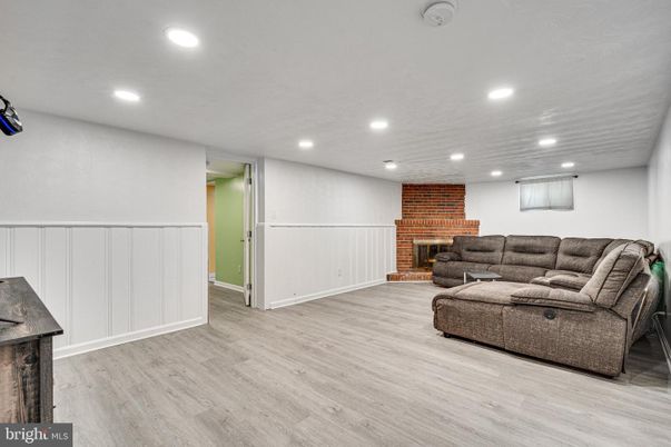Fireplace, Interior, Living room, Recessed Lighting, Stone Walls, Wood Texture Flooring